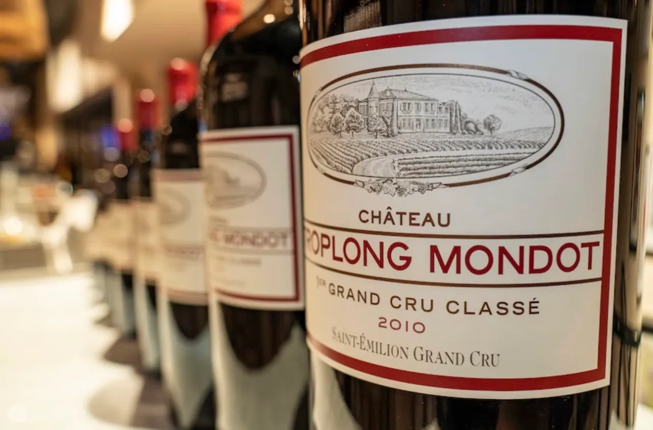 A row of bottles seen close along their labels, the nearest reading Château Troplong Mondot, 1er Grand Cru Classé, 2010